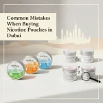 A clean, modern flat lay of nicotine pouch cans on a neutral background featuring a subtle Dubai skyline. On one side are neatly arranged premium HN Pillow pouches; on the other, blurred cans with a magnifying glass and warning icons represent common buying mistakes like unclear labeling and strength confusion.