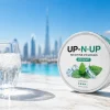 Nicotine pouch tin on sun-drenched surface in Dubai summer heat with mint cooling visual